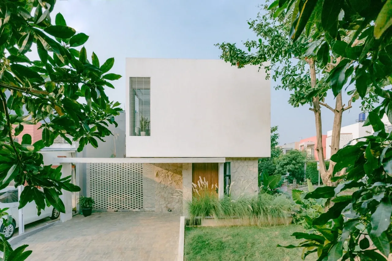 Rumasoka — tropical street facade framed by greenery